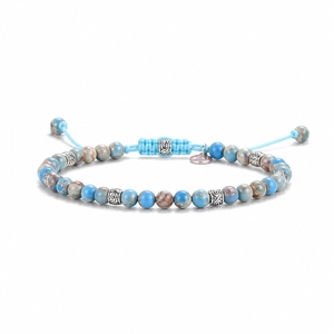 Beaded bracelet with blue and brown beads on a white background